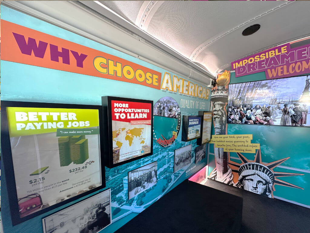 interior of united we pledge liberty bus featuring wall of why people choose america