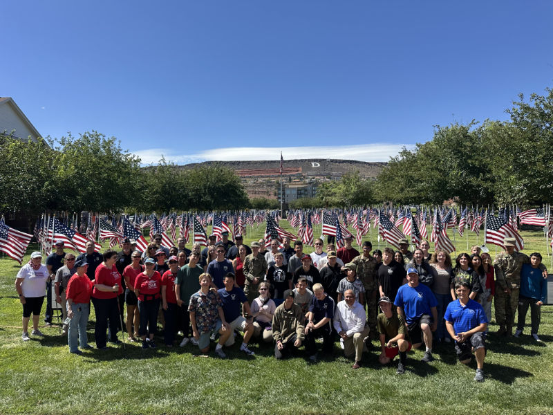 field of heros people in front of american flags for memorial